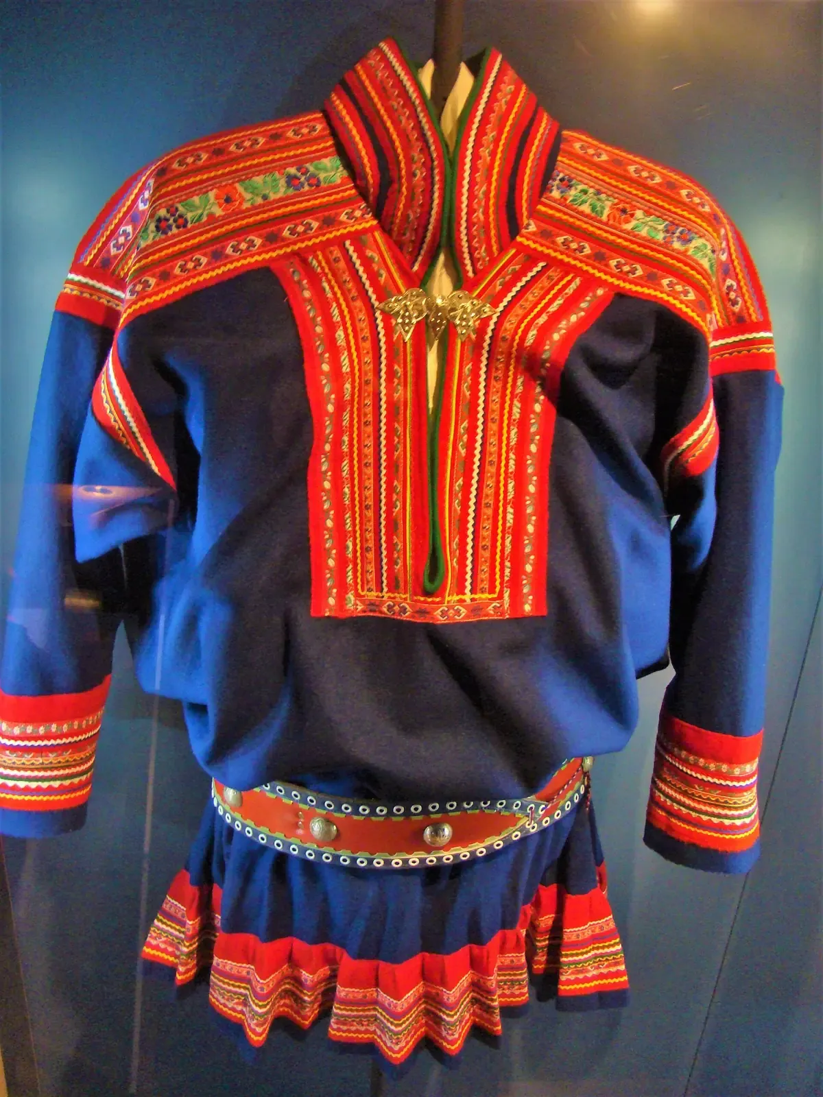 A blue and red Sámi gákti on display, traditional dress seen in museums near routes of Tromso reindeer sledding